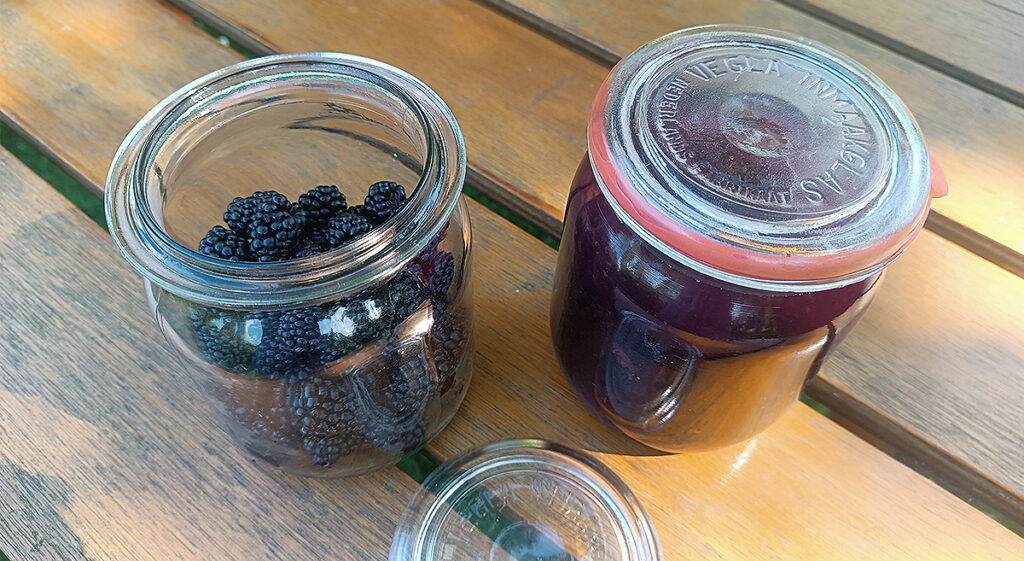 jars with blackberries and blackberry liqueur
