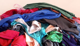 pile of cloths for declutter your closet