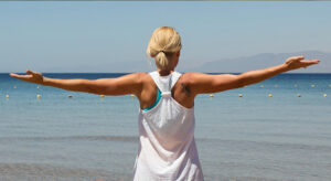 Letting go image arms wide at the beach