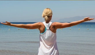 Letting go image arms wide at the beach